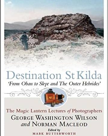 The book cover for *Destination St Kilda* features a vintage photograph depicting a stone hut situated in a rocky landscape, with mountains visible in the background. The title and author details are positioned below the image.