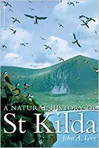 The cover of the book *A Natural History of St Kilda* by John A. Love shows a flock of seabirds flying above a grassy, mountainous landscape. The sky in the background is blue, and there are cliffs or steep slopes characteristic of St Kilda’s terrain. The image visually represents natural features associated with the island group and its wildlife.