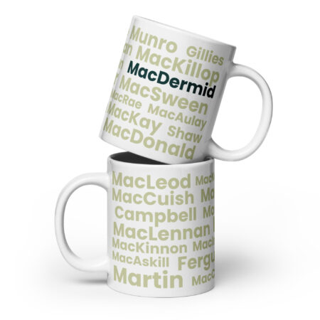 The Mug - MacDermid is a white ceramic mug featuring Scottish clan surnames in various green shades. The surname “MacDermid” appears prominently at the top. This design makes the mug suitable for a stacked display.