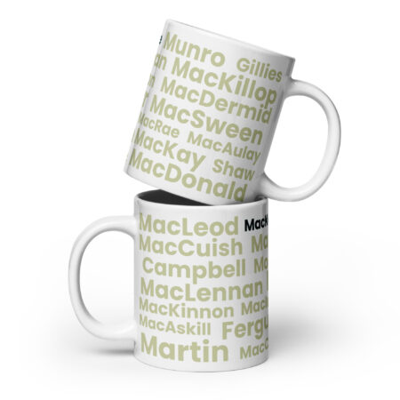 Two white Mug - MacKenzie mugs are stacked. Each mug features Scottish surnames—MacLeod, MacDonald, MacKay, and MacKenzie—printed in light green and black text on a clean white background.
