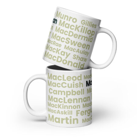 Two white mugs labeled Mug - MacLean are stacked. Each mug features a green and gray pattern displaying various Scottish surnames, including MacLean. The background is plain white.