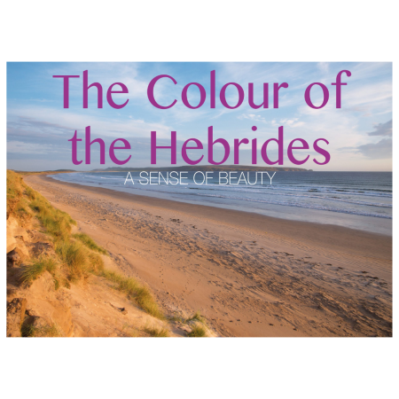 A sandy beach with grassy dunes and gentle waves under a blue sky, with the text: The Colour of the Hebrides: A Sense of Beauty.