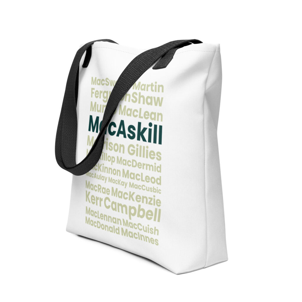 Understood. Here is a factual description based on your prompt: The Tote bag - MacAskill is a white tote bag featuring black handles. The design displays various Scottish clan names in different shades of green and fonts. Among these names, MacAskill and Campbell are displayed more prominently than the others.