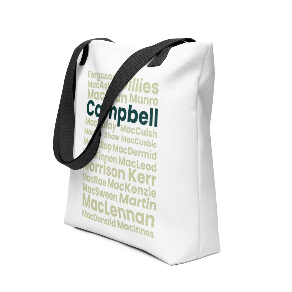 The Tote bag - Campbell is a white tote bag with black straps. The front of the bag features Scottish surnames such as Campbell, MacLennan, and Kerr printed in green and dark teal.