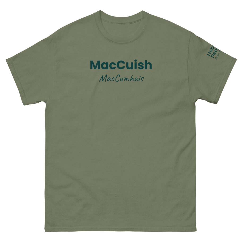 Understood. Here is a factual description: The Unisex T-shirt - MacCuish in sage green has “MacCuish” printed in bold dark green lettering on the chest. Below this, the name “MacCumhaís” appears in script font. There is also small dark green text located near the right sleeve hem.