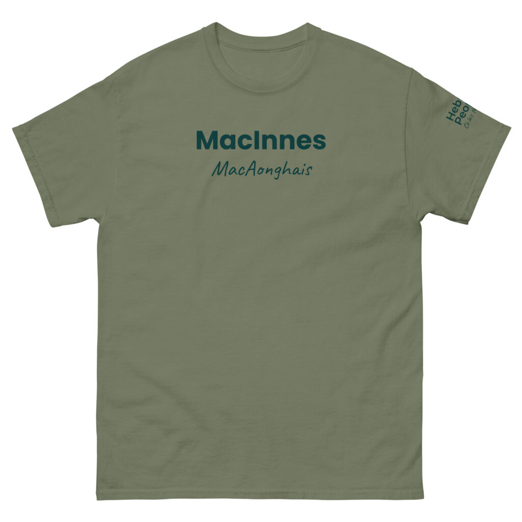 The Unisex t-shirt - MacInnes is olive green in color. The front features MacInnes in bold dark green text, with MacAonghais in script positioned below it on the chest. There is also small lettering on the right sleeve near the shoulder.