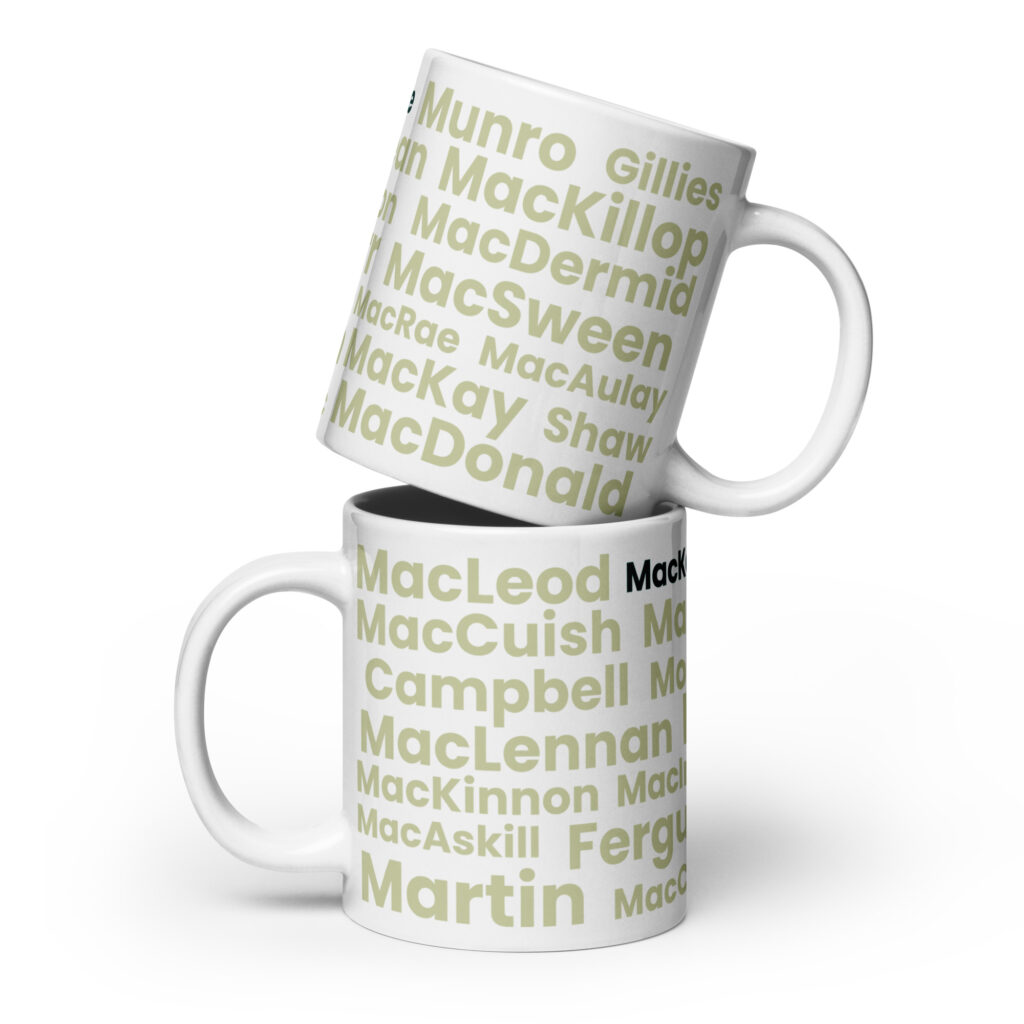 Two white Mug - MacKenzie mugs are stacked. Each mug features Scottish surnames—MacLeod, MacDonald, MacKay, and MacKenzie—printed in light green and black text on a clean white background.