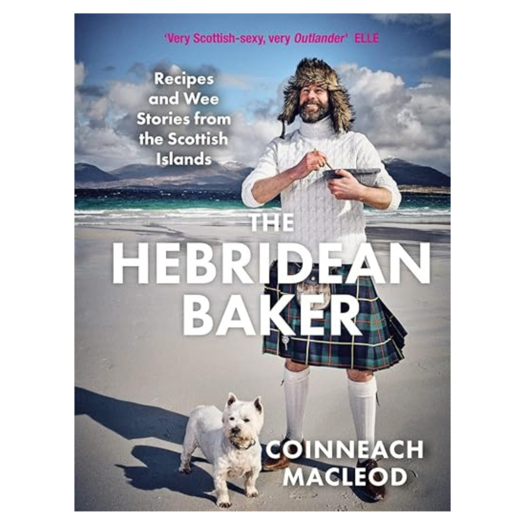 A man in a kilt holding a rolling pin stands on a beach before mountains. A small white dog sits nearby. Text: The Hebridean Baker—recipes and stories from the Scottish Islands.