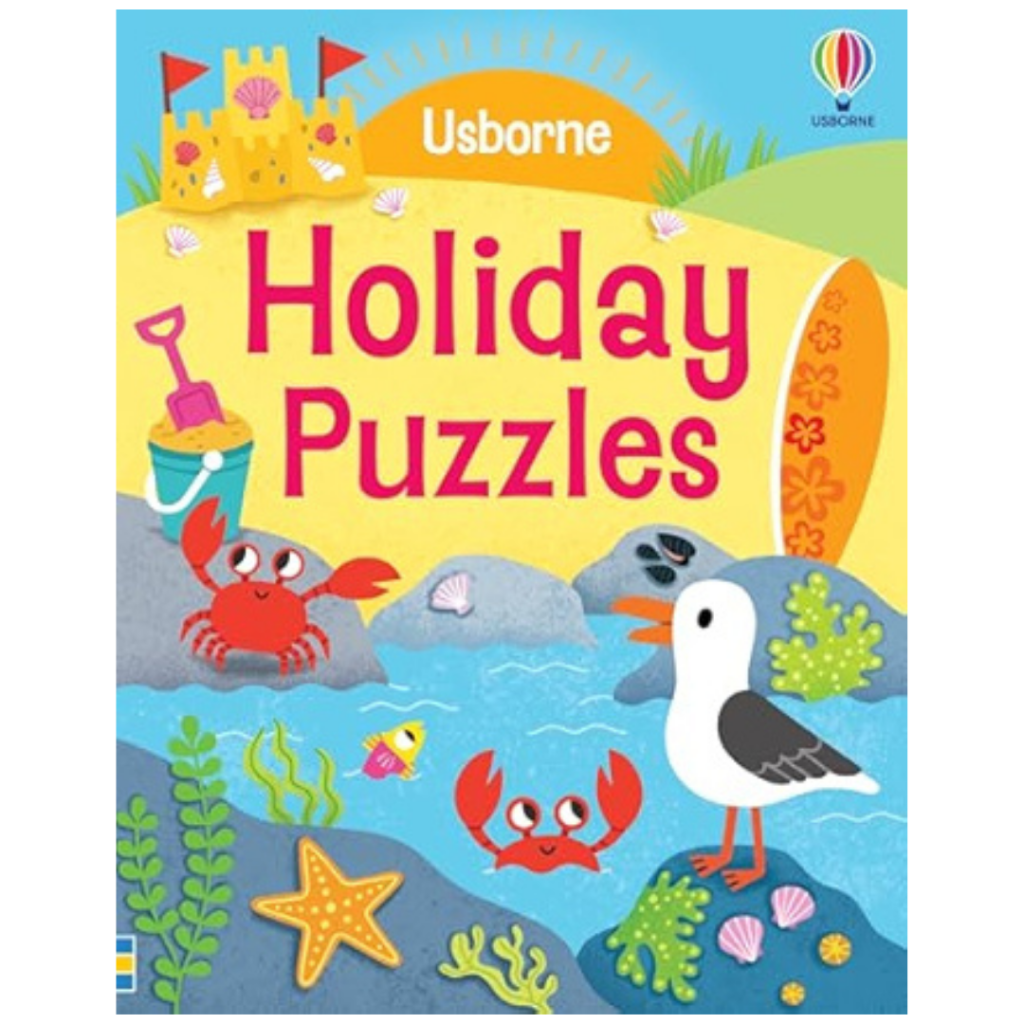 Colorful illustrated book cover titled Usborne Holiday Puzzles with two red crabs, a seagull, sandcastle, shells, starfish, and plants.
